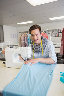 Smiling student using sewing machine