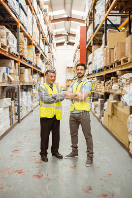 Warehouse team standing with arms crossed