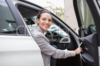 Businesswoman sitting in drivers seat