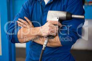 Mechanic holding a drill tool