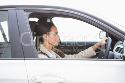 Focused pretty business woman driving