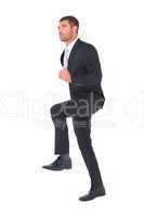 Businessman walking with his leg up