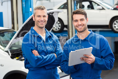 Team of mechanics smiling at camera