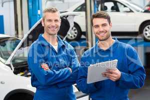 Team of mechanics smiling at camera