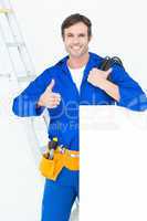 Electrician with wire and bill board gesturing thumbs
