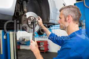 Focused mechanic adjusting the wheel