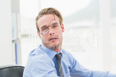 Tired businessman with glasses waking up