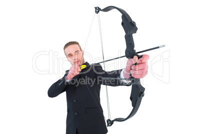 Concentrated businessman shooting a bow and arrow