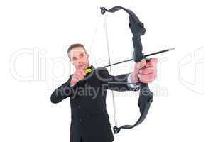 Concentrated businessman shooting a bow and arrow
