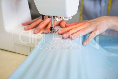 Close up of student using sewing machine