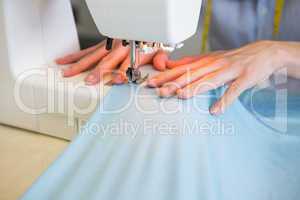 Close up of student using sewing machine