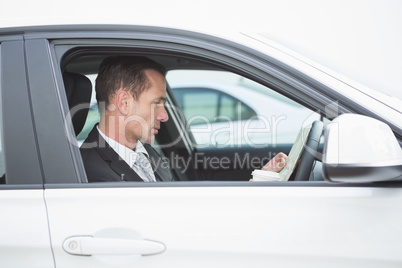 Serious businessman reading a map