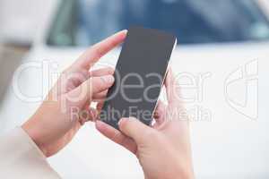 Close up of businesswoman holding smartphone