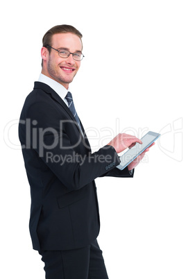 Happy businessman using his tablet pc