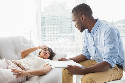 Woman lying on sofa talking to her therapist