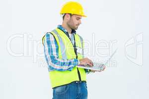 Repairman in reflective workwear using laptop