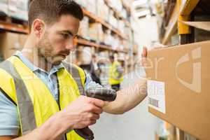 Warehouse worker scanning barcodes on boxes