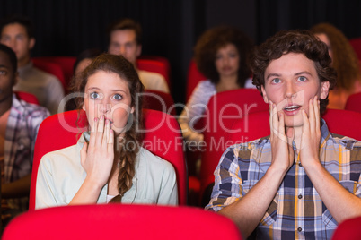 Young couple watching a film