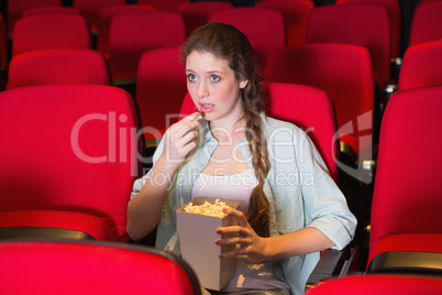 Young woman watching a film