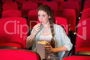 Young woman watching a film