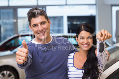 Smiling couple holding their new car key