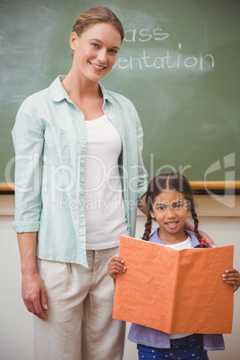 Cute pupil smiling at camera during class presentation