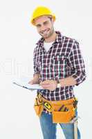 Confident male repairman writing on clipboard