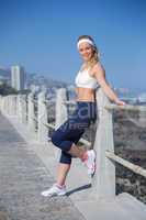 Fit blonde standing on the pier