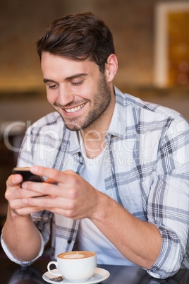 Young man sending a text