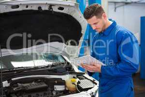 Mechanic writing on a clipboard