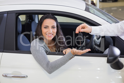 Salesman giving keys to a smiling woman