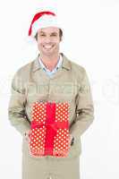 Happy delivery man wearing Santa hat while holding gift