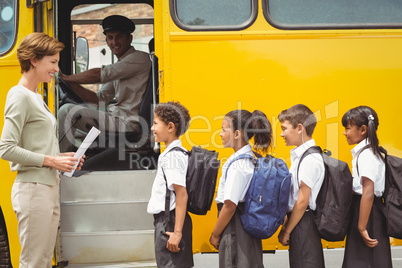 Cute schoolchildren waiting to get on school bus