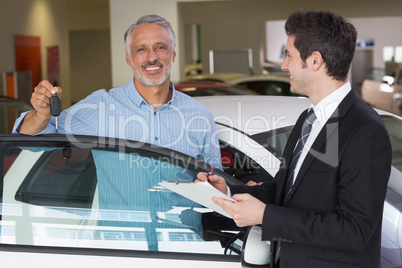 Smiling customer showing his new key