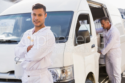 Painter smiling leaning against his van