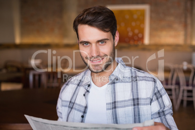 Young man reading the newspaper