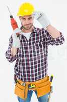 Confident handyman holding drill machine