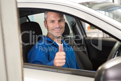 Mechanic showing thumbs up to camera
