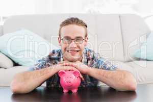 Smiling man with a piggy bank