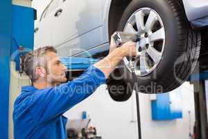 Mechanic adjusting the tire wheel