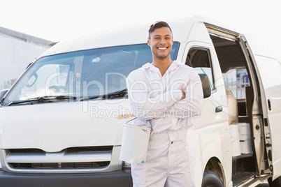 Painter smiling leaning against his van