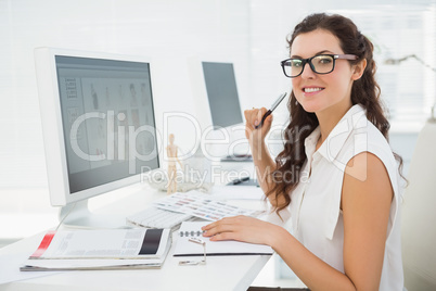 Portrait of smiling businesswoman sitting at desk