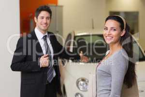 Businessman showing a car to a woman