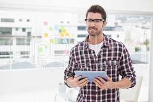 Happy businessman with glasses holding tablet