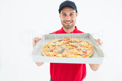 Happy delivery man showing fresh pizza