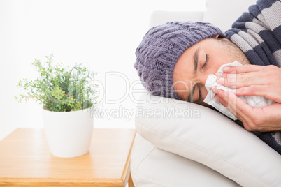 A sick man lying on the sofa