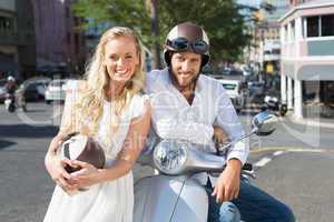 Attractive couple with their scooter