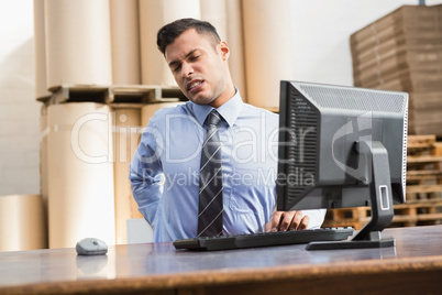 Warehouse manager working on computer