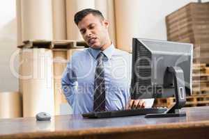 Warehouse manager working on computer