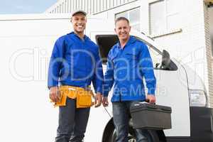 Smiling handymen looking at camera